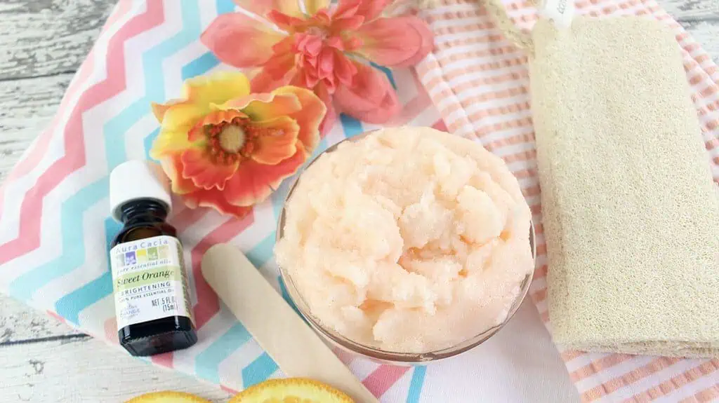 orange coconut sugar scrub with flowers and different colored patterns