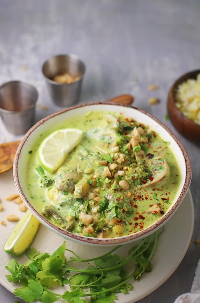 instant pot thai green curry in a bowl with peanuts and cilantro