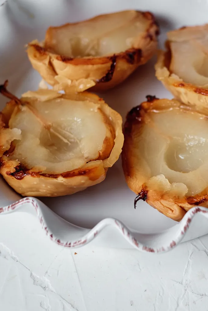 overhead shot of pear tarts in a white casserole baking dish