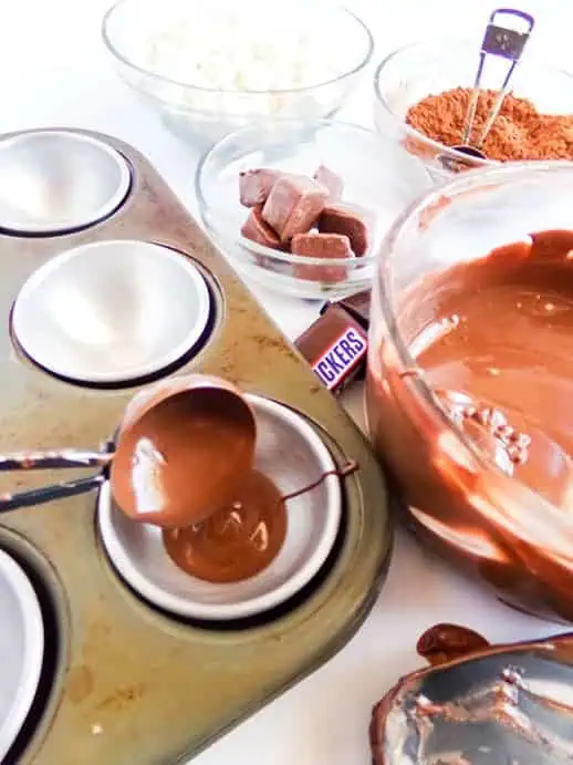 melted chocolate in mold for snickers hot cocoa bombs
