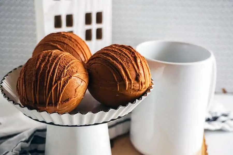 instant pot hot cocoa bombs by a white coffee cup