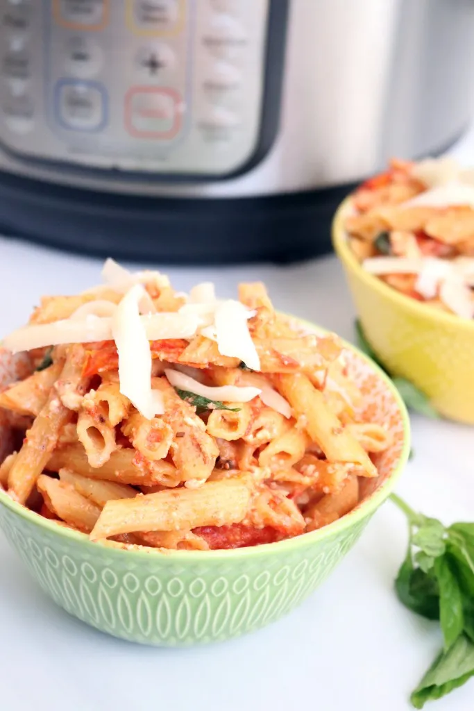 instant pot with bowls of feta pasta form tiktok