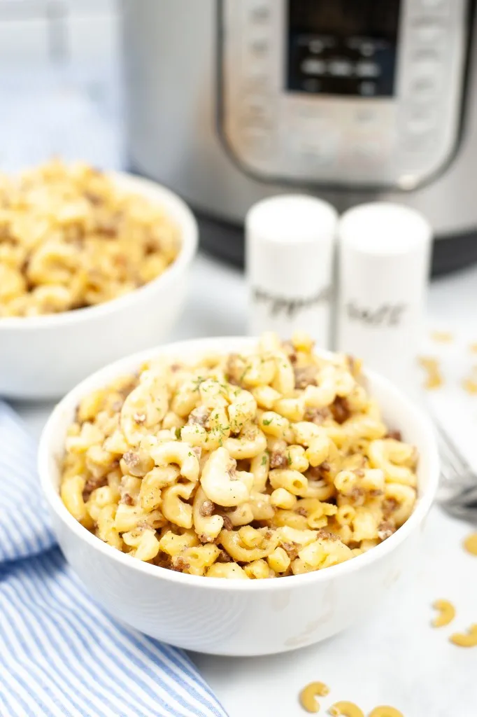 instant pot hamburger helper in little white bowls with salt and pepper shaker