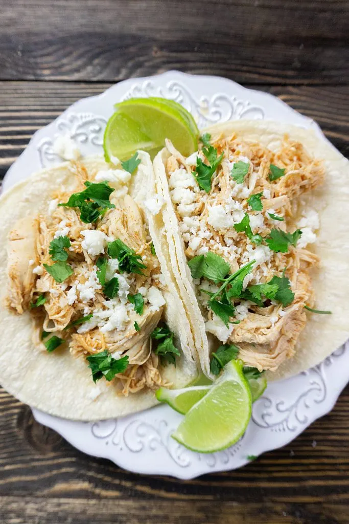 Instant pot key lime chicken tacos with fresh cilantro and queso blanco cheese