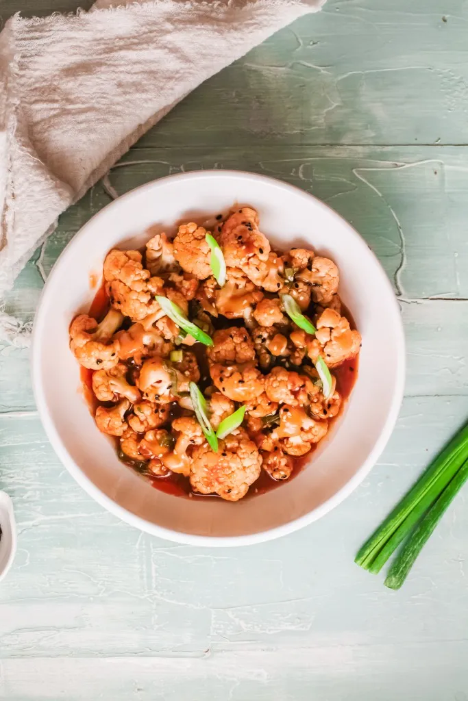 white bowl filled with korean caulifwer made in an instant pot