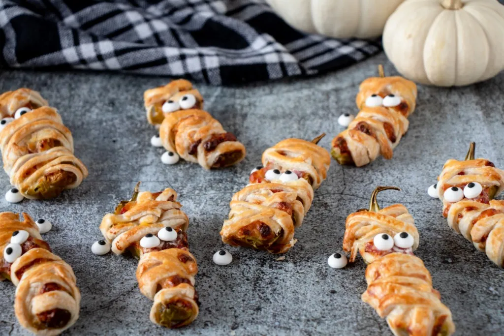 mummy jalapeno poppers on a speckeld background