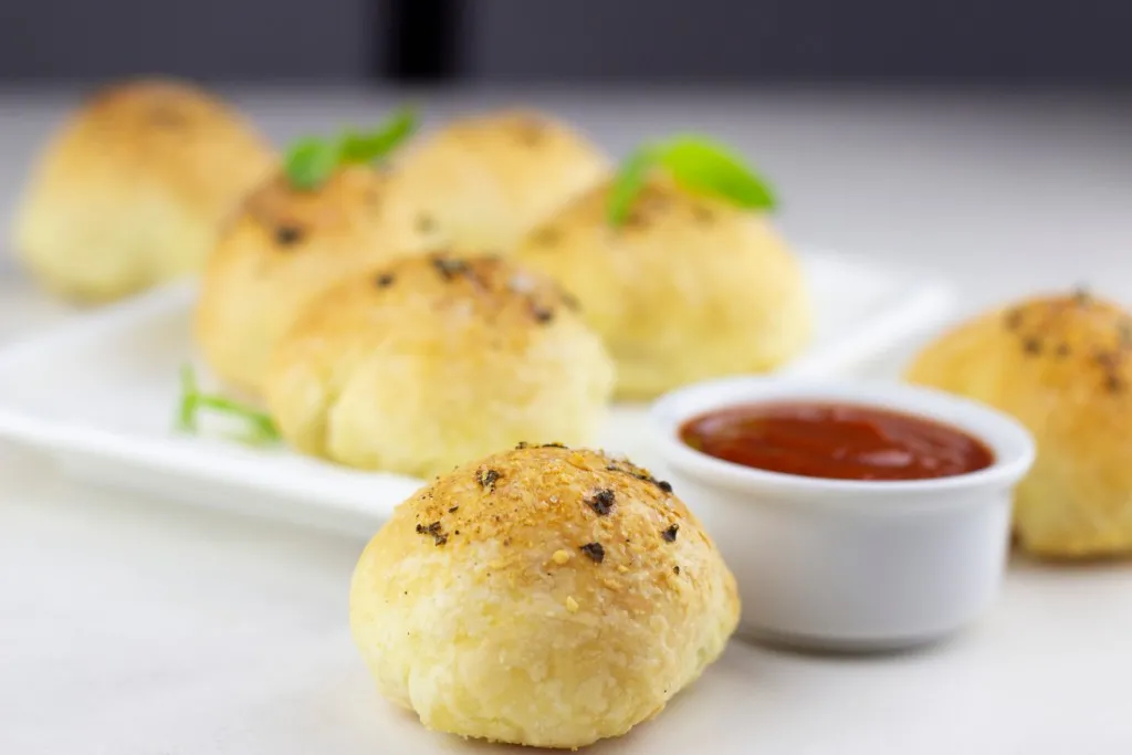 easy pizza bites recipes with a side of marinara sauce in a white ramekin