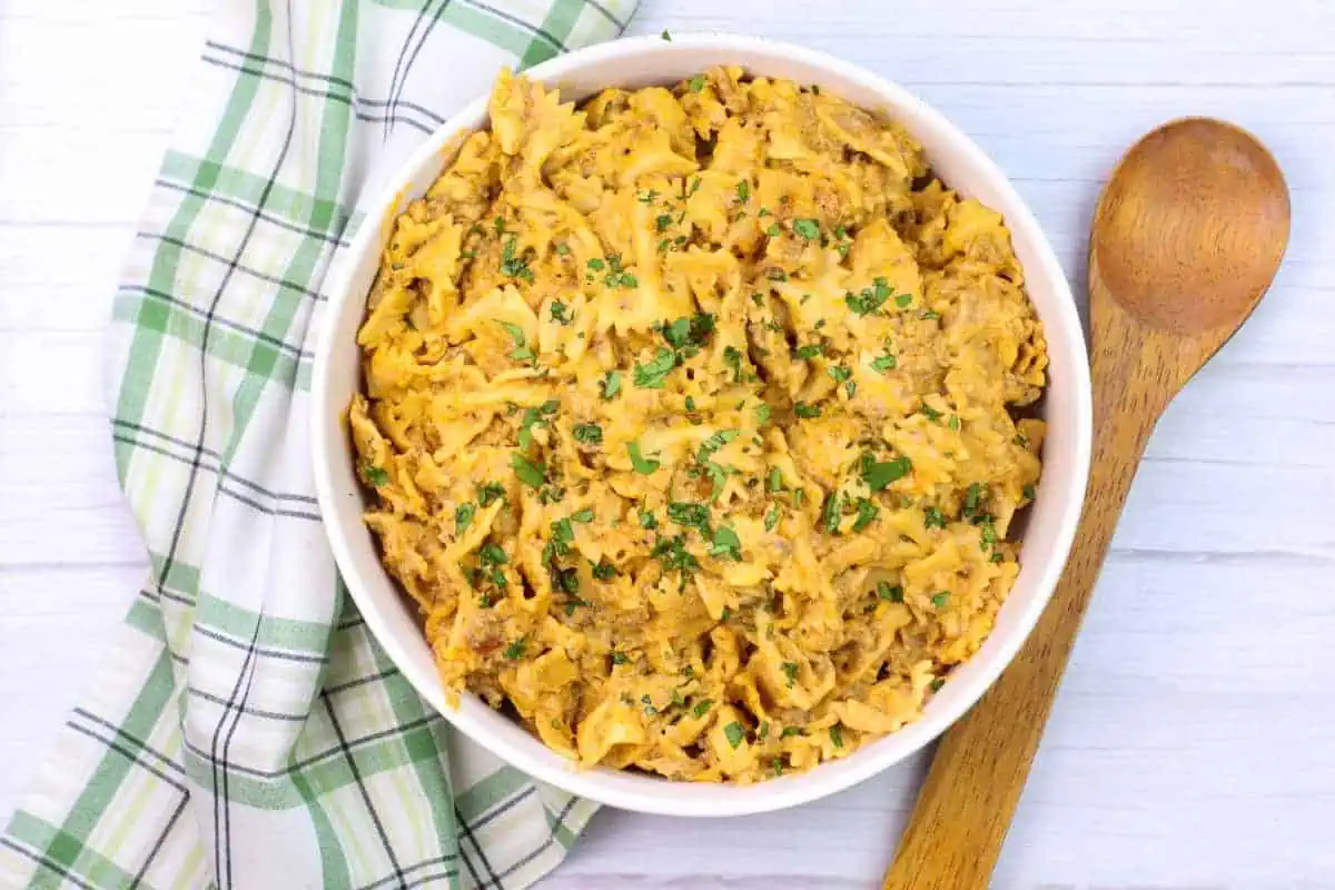 instant pot taco pasta in a white bowl and wooden spoon