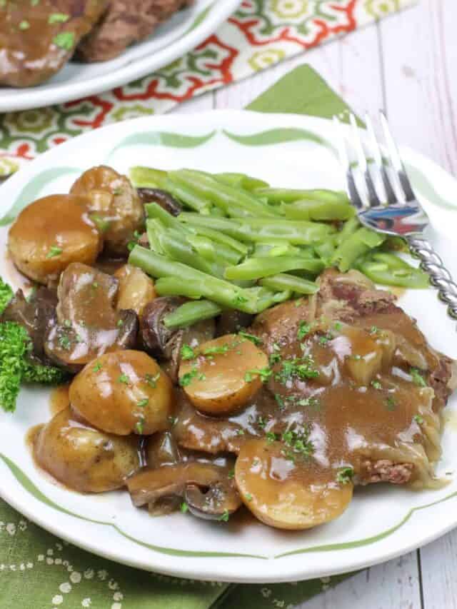 Close-up of cube steak in the Instant Pot with onions and gravy