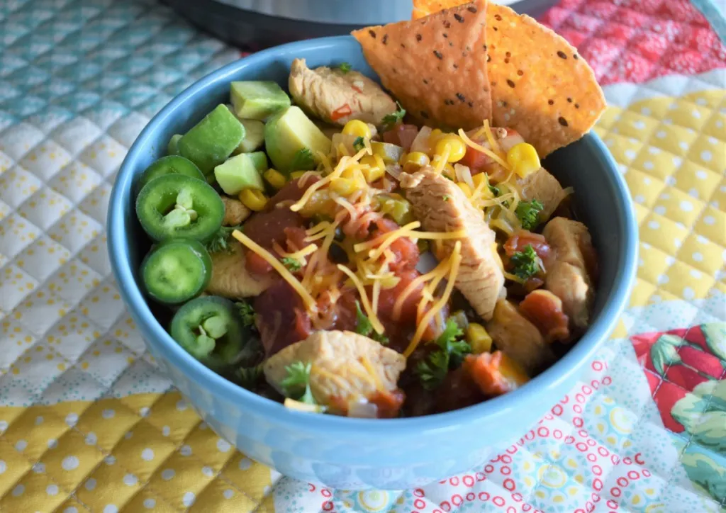 easy instant pot southwest chicken soup with fresh avocado and sliced peppers