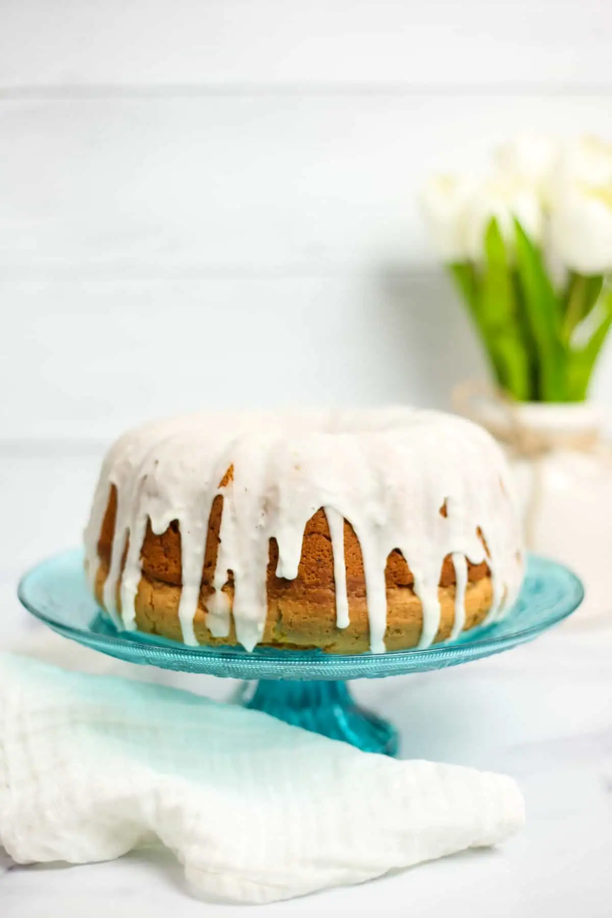 lemon ginger bundt cake on a blue glass platter
