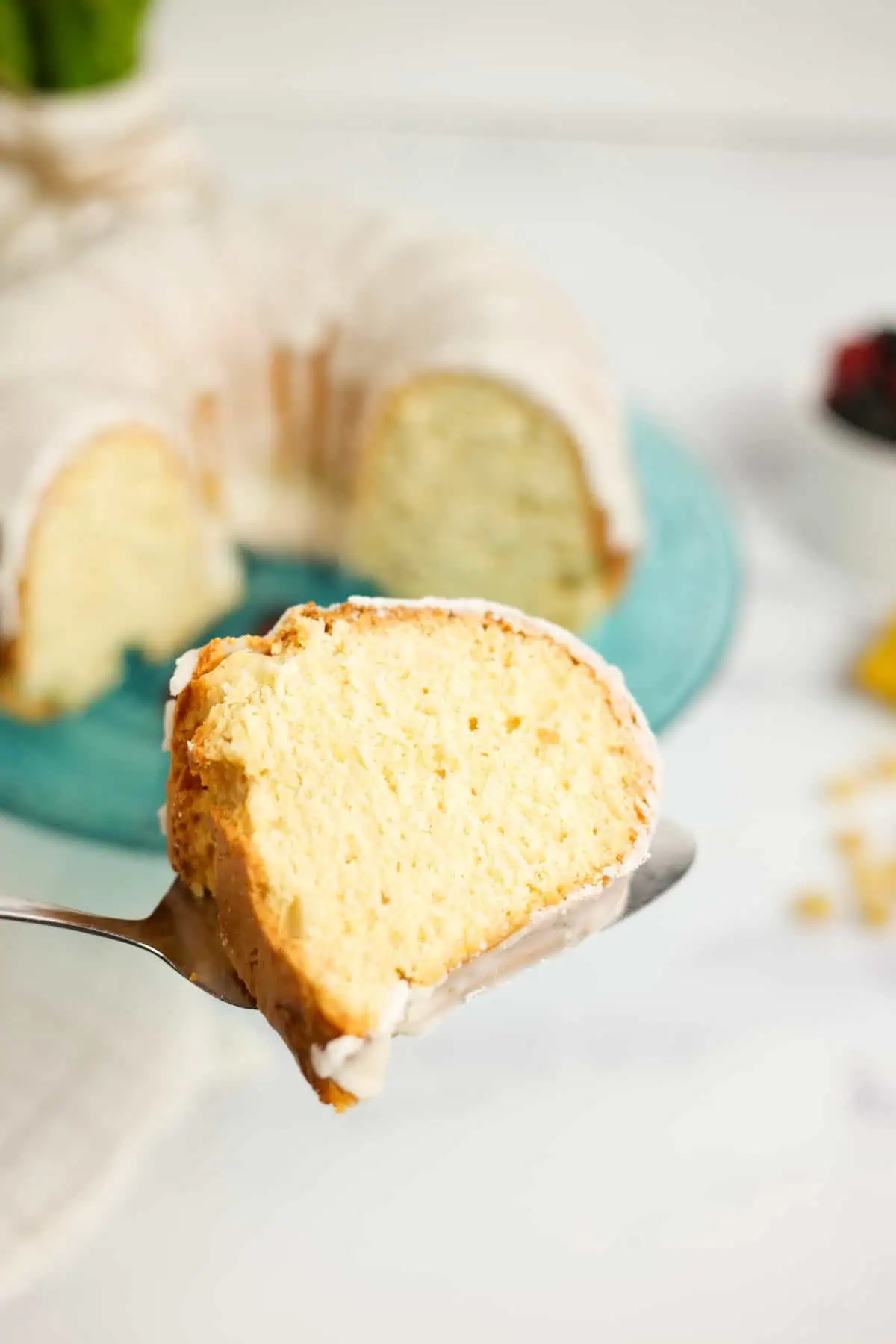 a slice of lemon ginger bundt cake on a serving utensil
