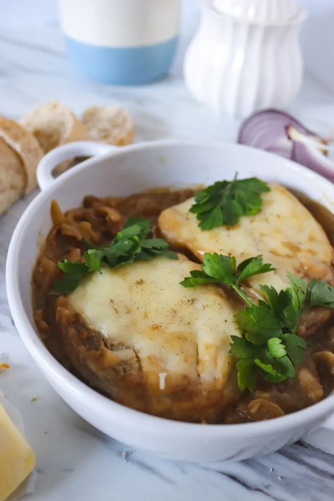 baked french onion porks in a white dish