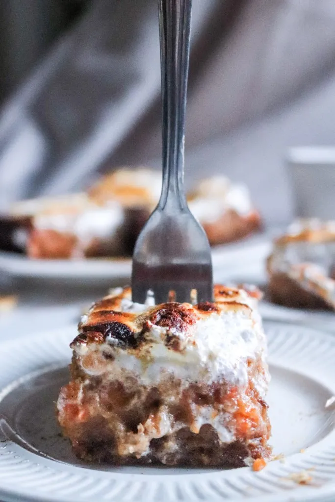 fork standing in a slice of sweet potato pie bar