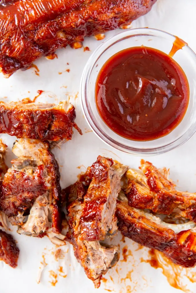 instant pot baby back ribs with a bowl of bbq sauce
