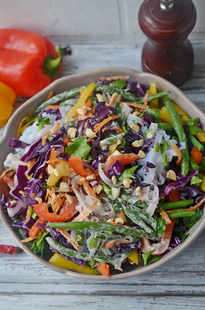 over head view of thai noodle peanut salad that's served chilled in a bowl