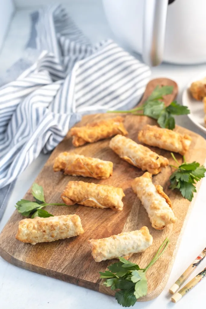 egg rolls on a wooden cutting board