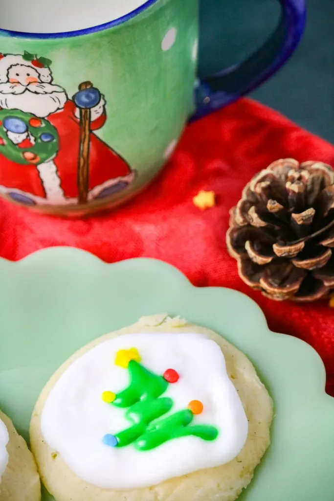 christmas meltaway cookies on a green plate with a pinecone