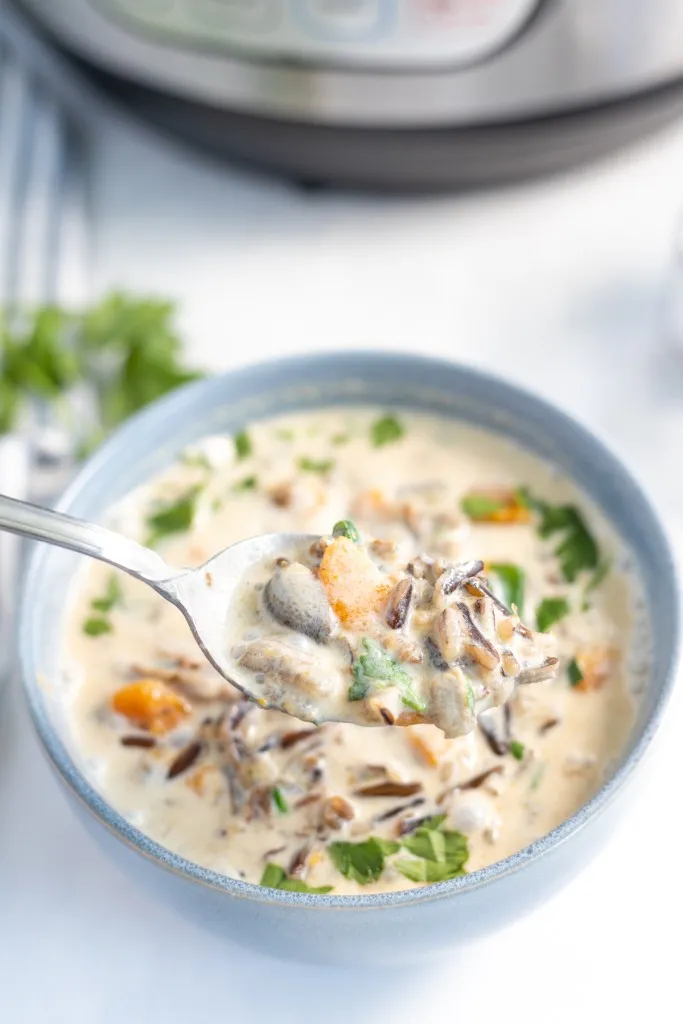 a spoonful of instant pot wild rice and mushroom soup