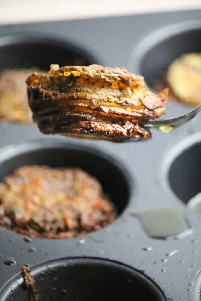 potato stacks recipe from a muffin tin on a fork