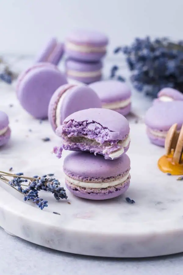 Close-up of smooth lavender macaron shells with a soft chew
