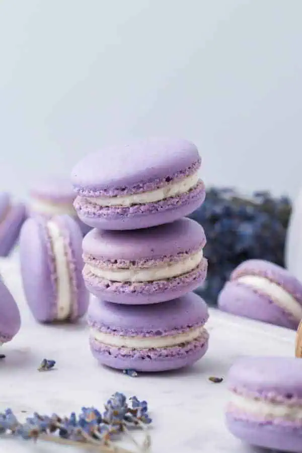 Stack of sandwiched vanilla buttercream between two lavender macaron shells