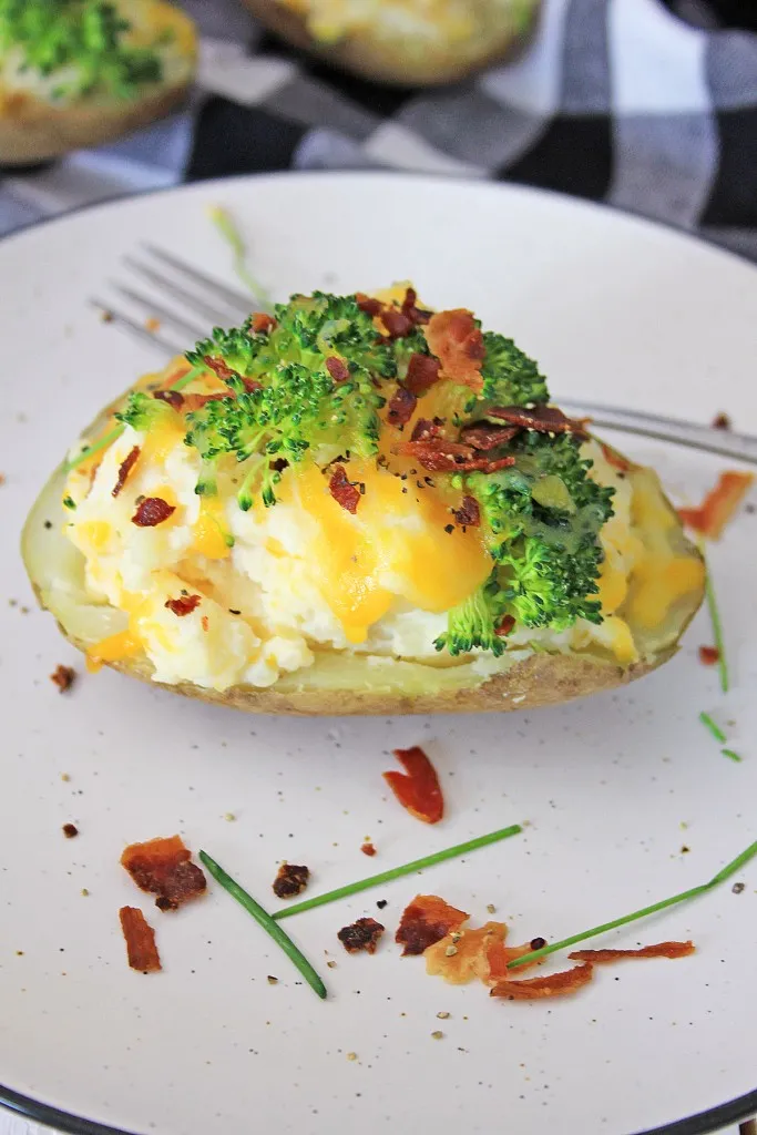 loaded baked potato made in the instant pot and served on a white stone plate