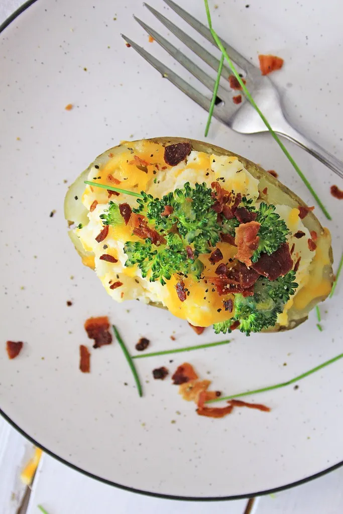 overhead shot of a delicious instant pot loaded baked potato served with fresh chives