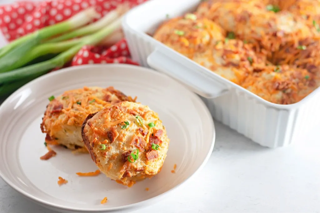 bacon cheddar ranch biscuits on a white plate and large white ceramic dish