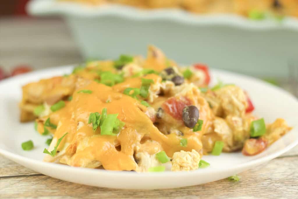 easy chicken southwestern recipe idea on a white plate and a casserole dish in the background