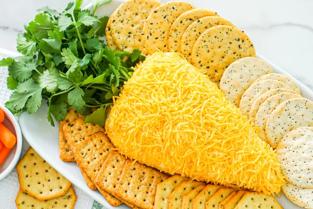 close up view the easter carrot cheese ball with sides of crackers