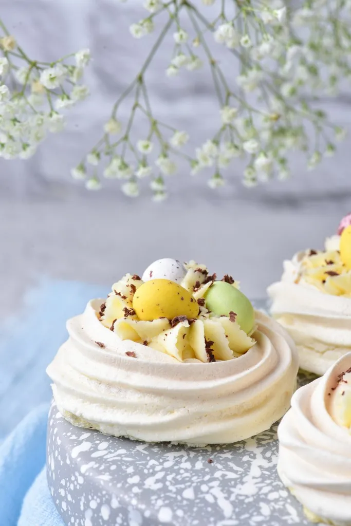 delicious and easy to make Easter Meringue Nests filled with cream cheese and and cadbury mini eggs