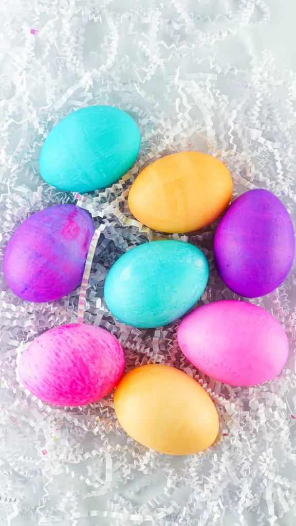 multicolored easter eggs on a news of crinkled paper