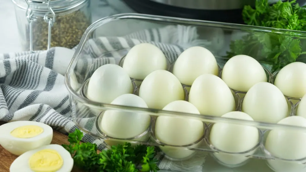 more eggs in a clear plastic container in front of an instant pot with fresh parsley