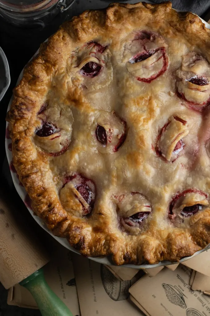 Freshly baked Eyeball Pie on a kitchen countertop, wooden rolling pin.