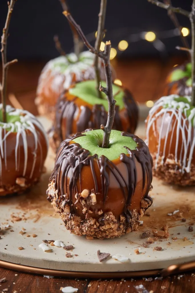 Best caramel apples on a wooden board.