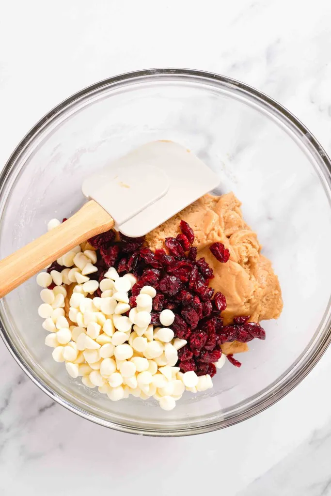 Bowl with cranberry bliss bar mixture, dried cranberries and white chocolate chips.