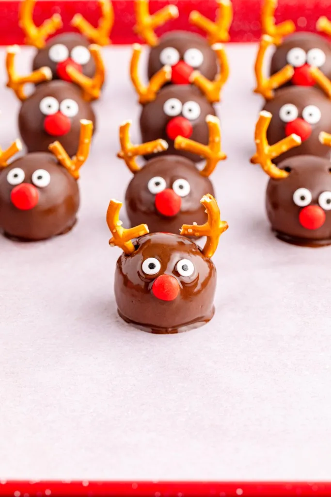 Decorated Reindeer Oreo balls on a baking tray.