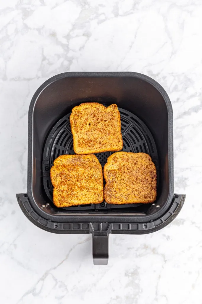 Overhead view of air fryer French toast with a golden brown crispy finish.