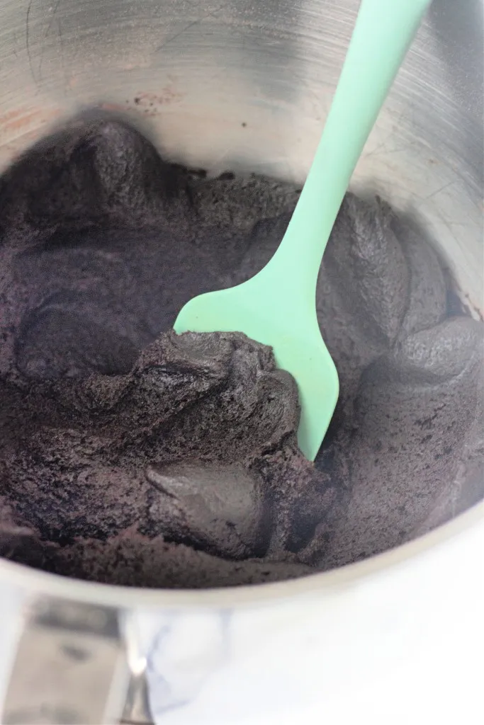 Close up of cosmic brownie cookies dough with a spatula.
