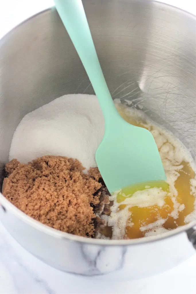 Mixing bowl with melted butter, granulated sugar, brown sugar, and vanilla extract.