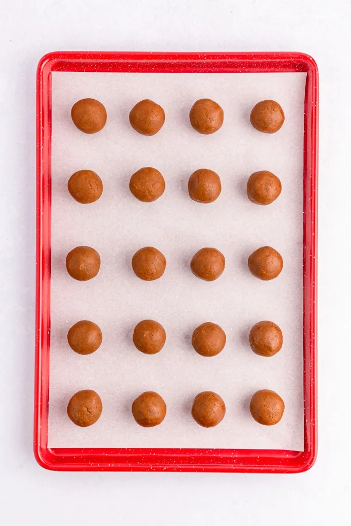 Baking tray with rolled Biscoff truffle balls.