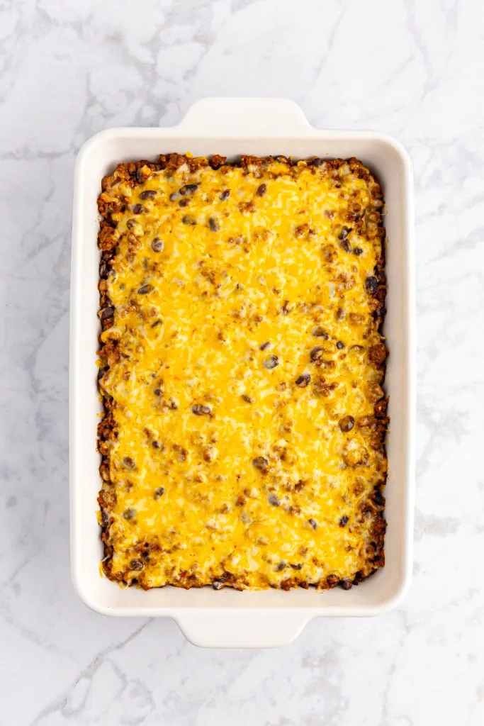 Baked taco casserole with melted cheese topping.