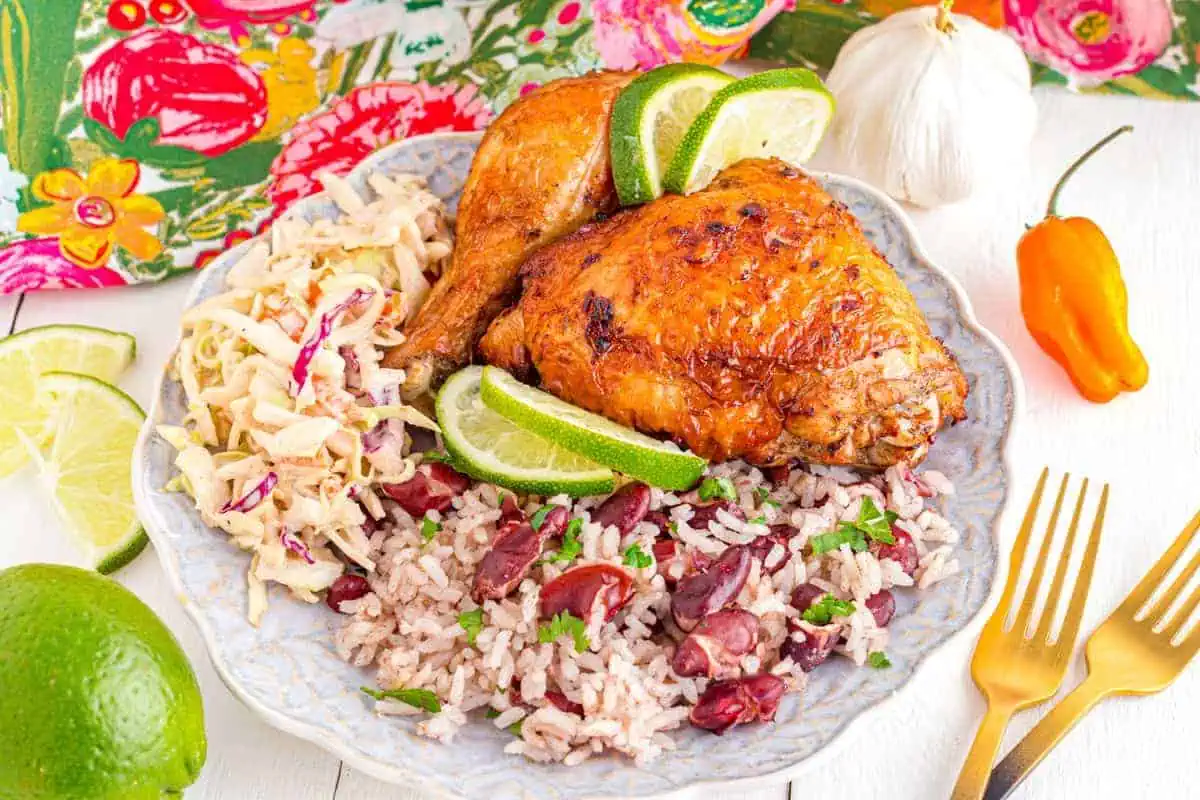 Jerk chicken with rice on a plate.