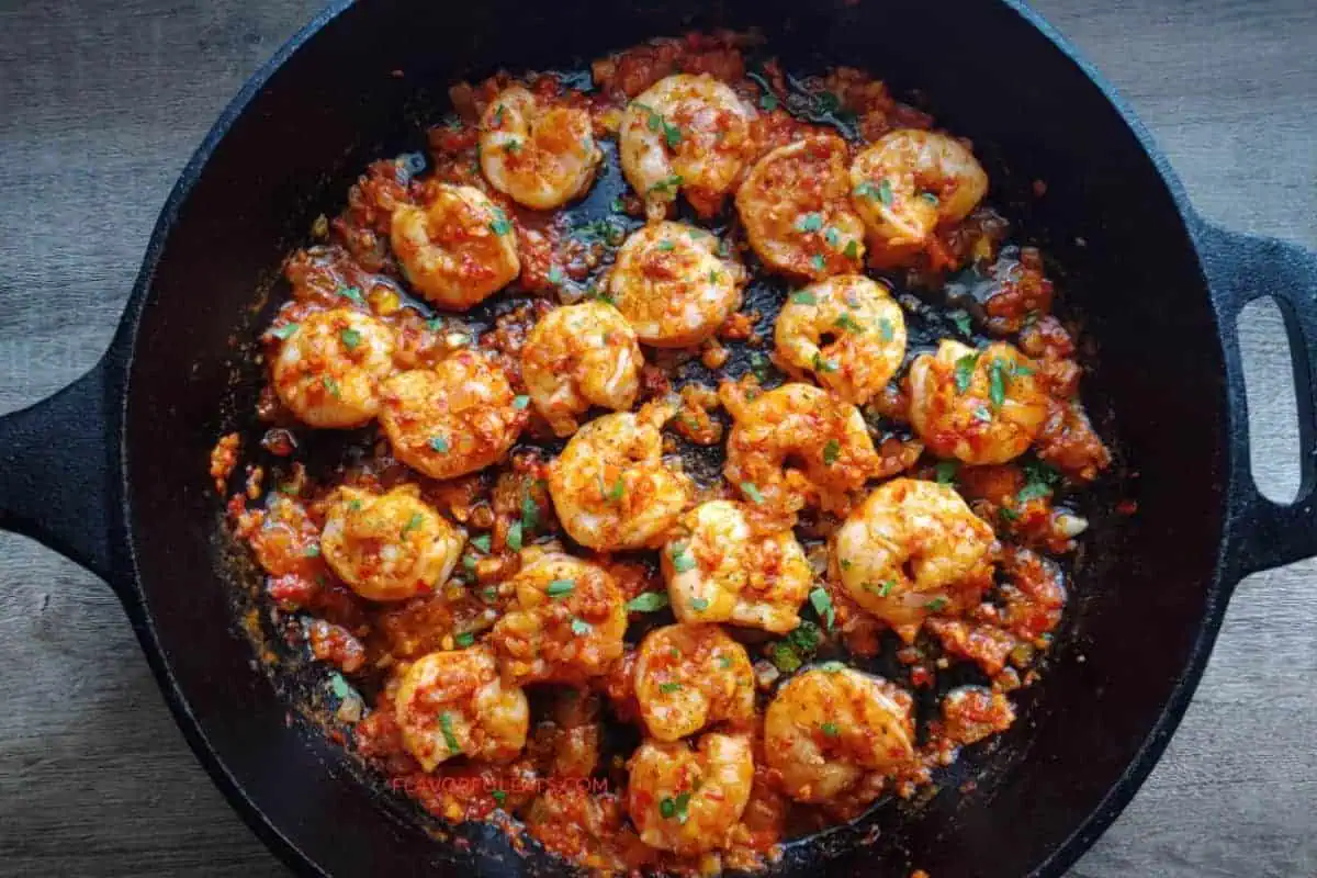 Harissa shrimp in a skillet.