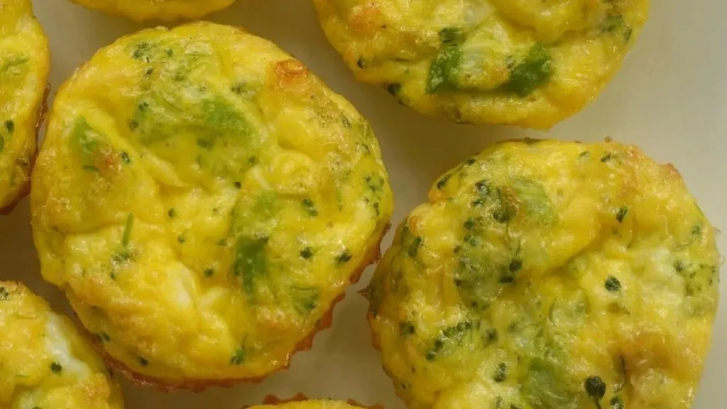 Egg bites on a plate with herbs.