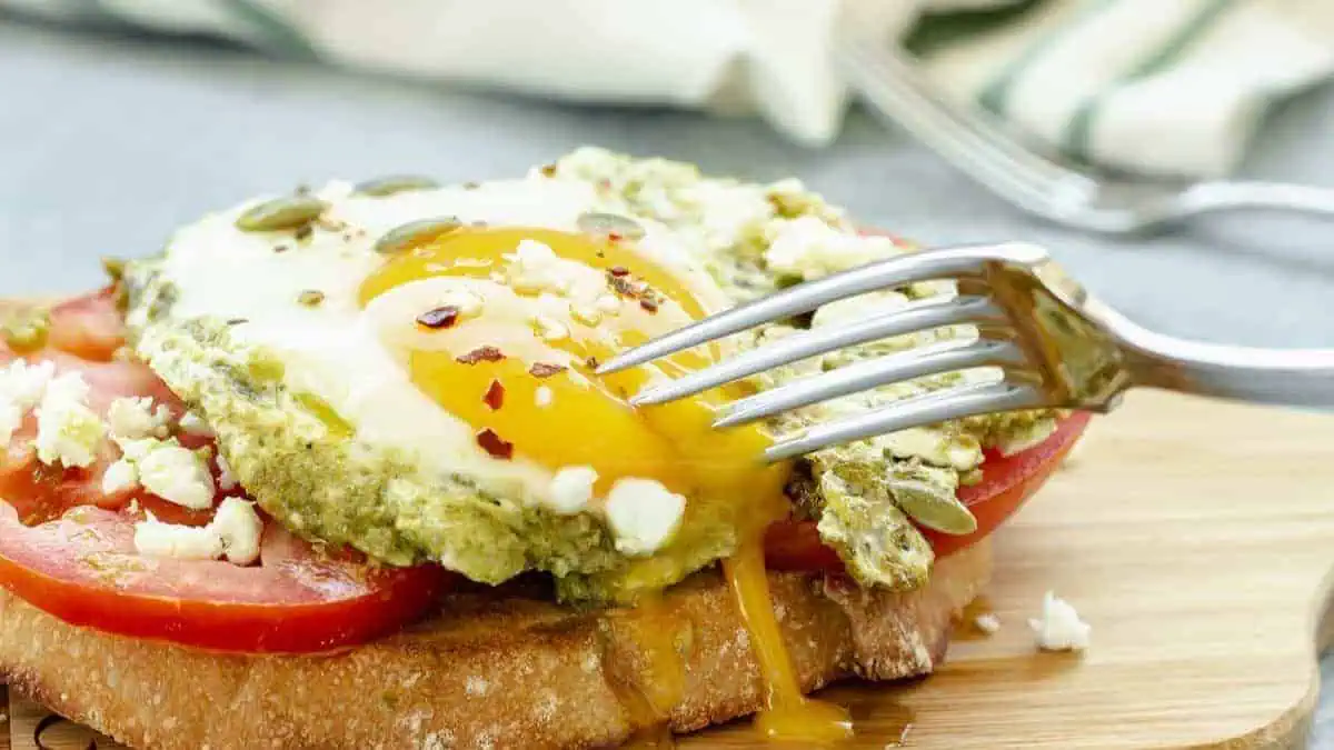 Toast topped with tomato and pesto eggs.