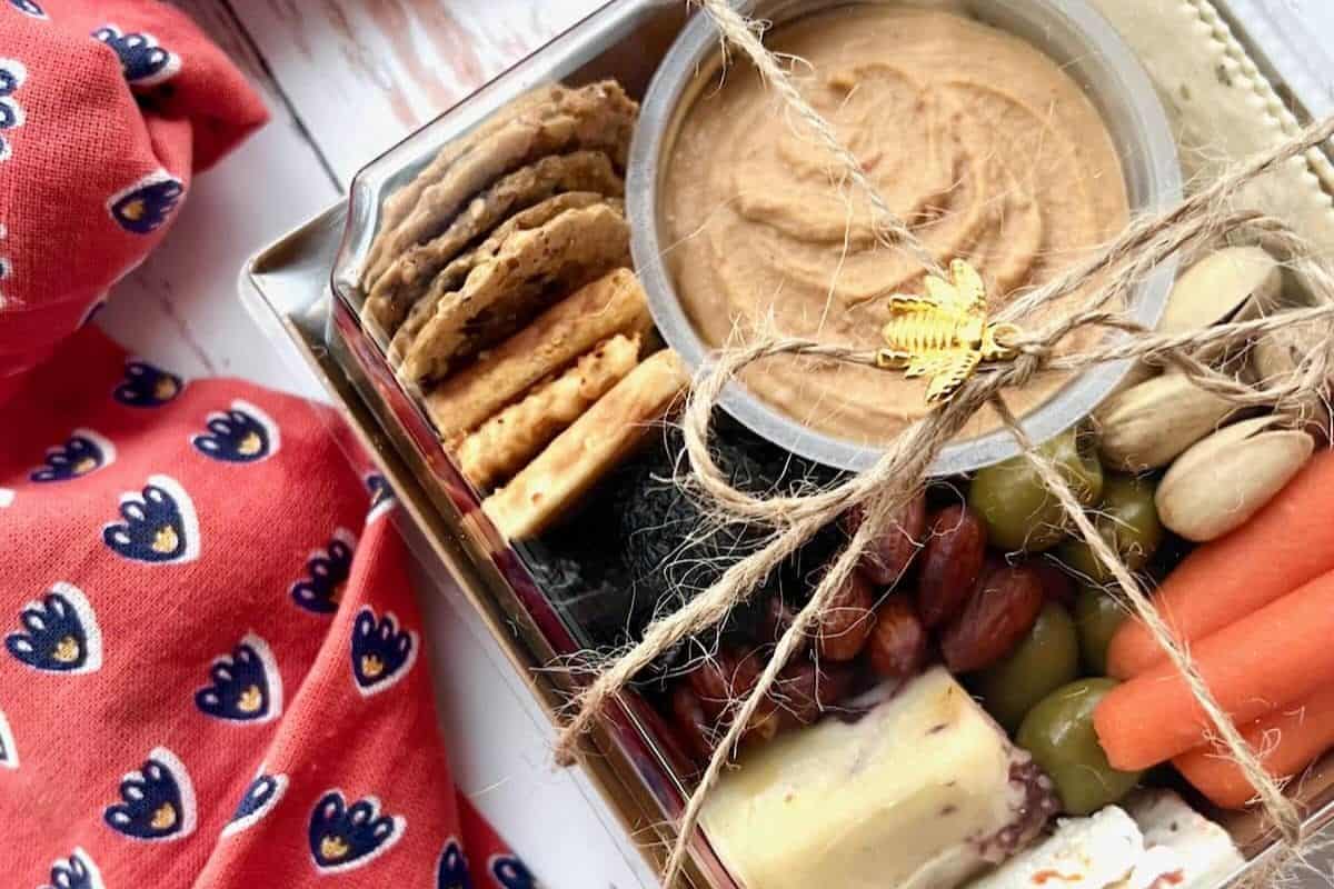 Hummus, Cheese, nuts, grapes in a box