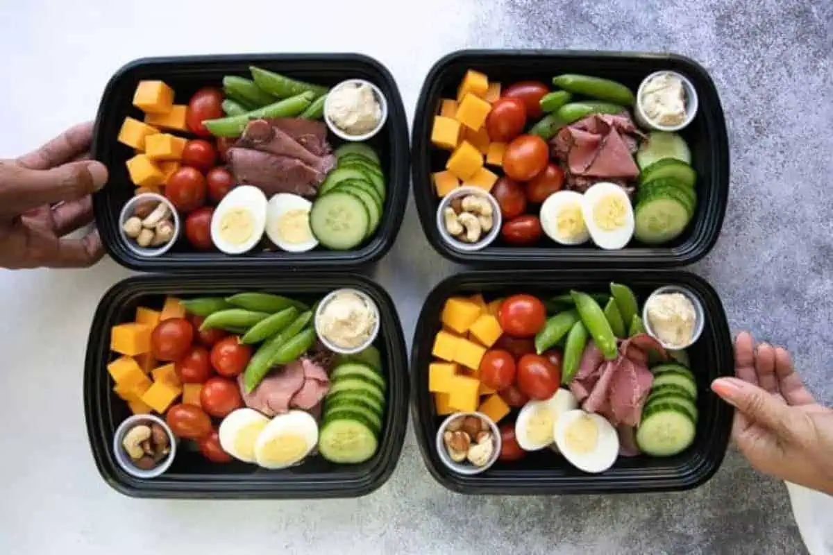 Protein Snack Packs filled with hard-boiled eggs, almonds, hummus, and crunchy veggies