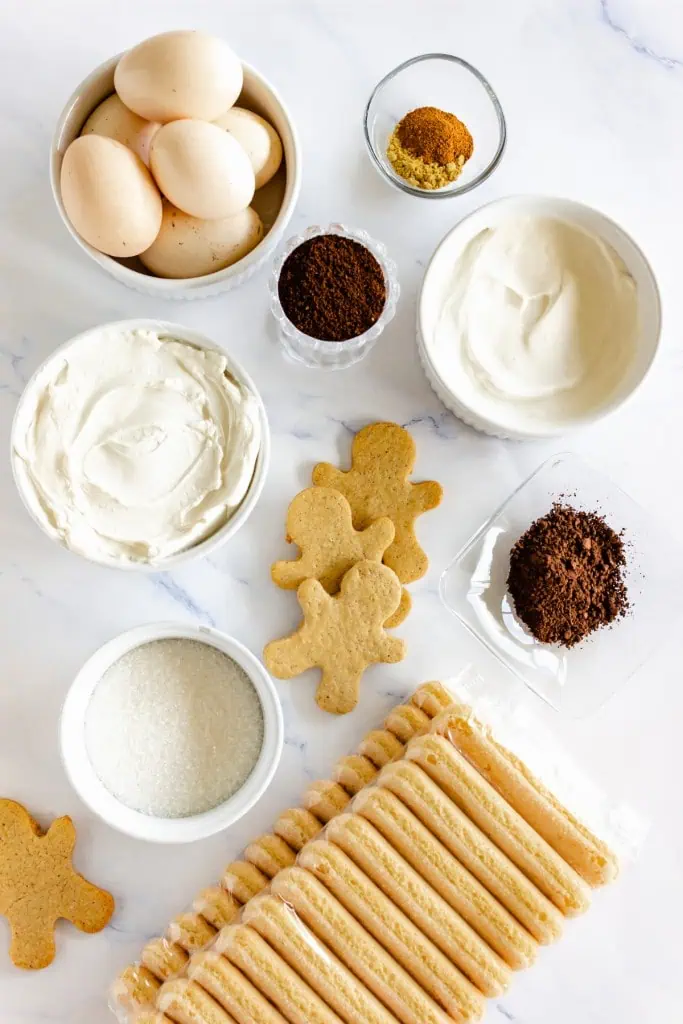 Ingredients for gingerbread tiramisu on a marble countertop.